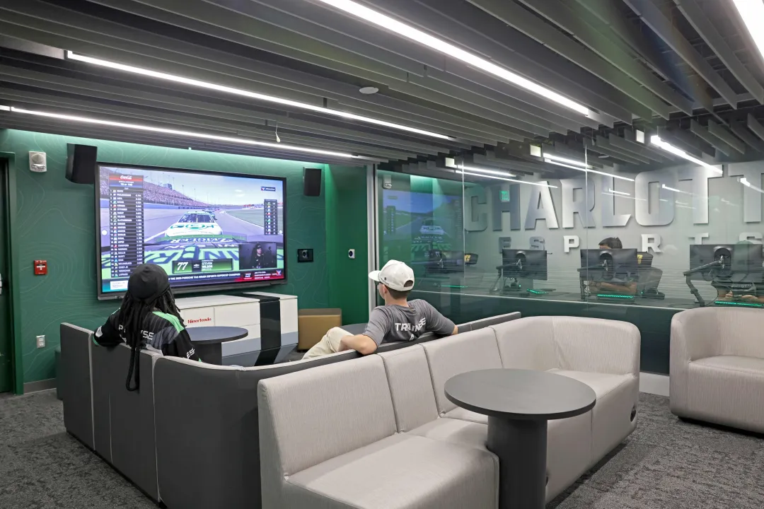 Students in the lounge of the new Charlotte Esports space, watching racing